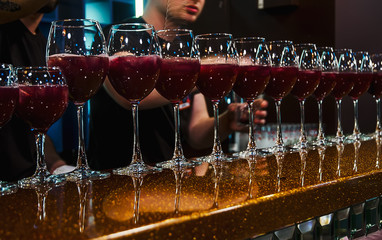 Bartender making cocktails on bar counter in the nightclub cocktail party