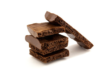 pieces of porous chocolate on a white background, isolate 