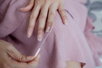 Woman doing manicure with nail file