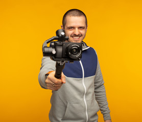 Videographer or blogger man pointing camera with gimbal