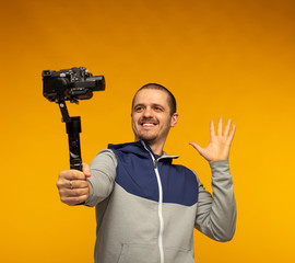 Man vlogger or blogger or videographer filming hisself on camera