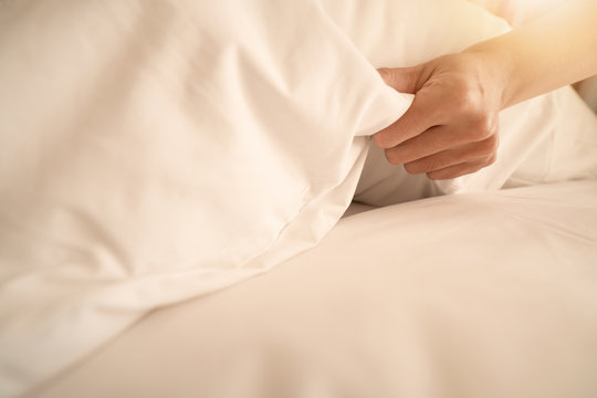 Female Hand Set Up White Bed Sheet In Room Hotel