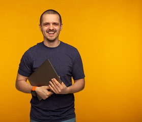 Freelancer or developer laughting and holding laptop