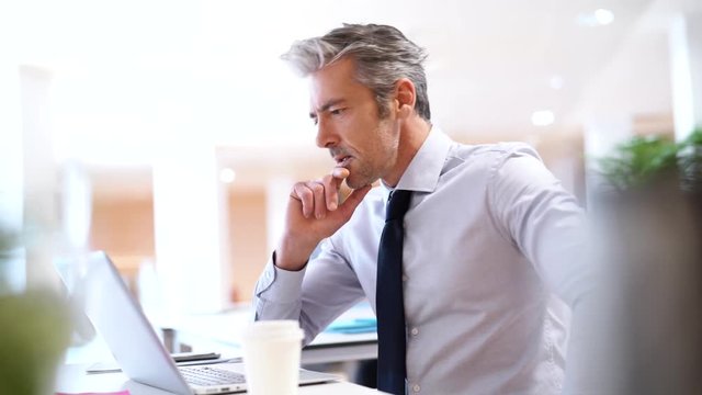 Handsome businessman working in contemporary office