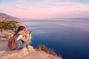 Naklejka premium Young beautiful girl traveling along the coast of the Mediterranean Sea.