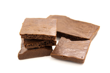 pieces of porous chocolate on a white background, isolate 