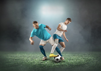 Naklejka premium Soccer player on a football field in dynamic action at summer da
