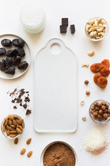 Ingredients for energy dates balls with cacao and nuts on white. Healthy food for vegan and children.