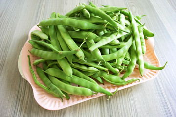 Green beans on wood table