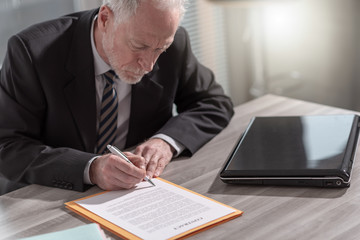 Businessman signing a document (Lorem ipsum text used)