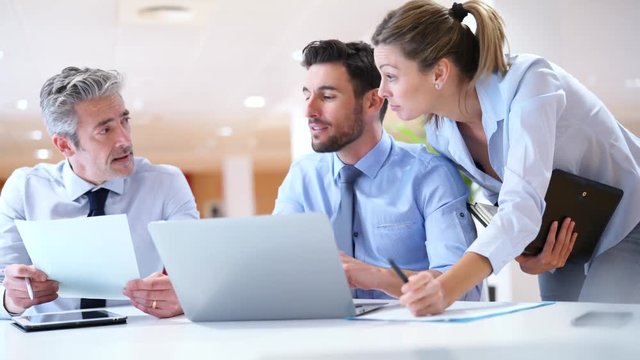 Mixed group of coworkers working together in contemporary office