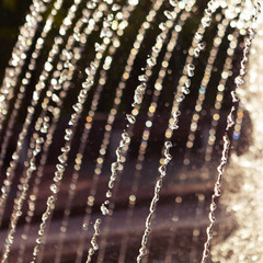 many jets of water in the backlight, colorful bokeh, concept of water