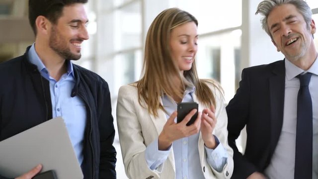 Business team walking to meeting in contemporary office