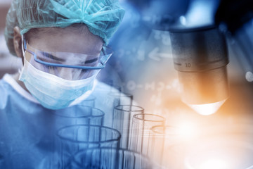 Doctor working in the operating room with microscope, medical research and development concept 