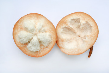Cut half ripe santol on white background