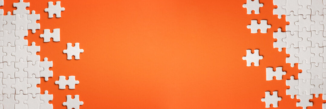 White details of puzzle on orange background