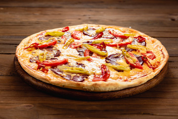Appetizing pizza on a wooden background
