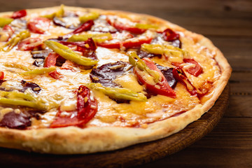 Appetizing pizza on a wooden background