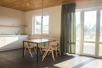 Cooking food on modern kitchen with furniture in grey color and wooden tabletop,Stylish kitchen interior in scandinavian style