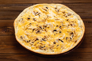 Appetizing pizza on a wooden background