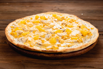 Appetizing pizza on a wooden background