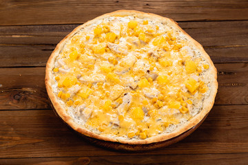 Appetizing pizza on a wooden background