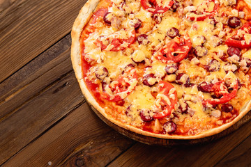 Appetizing pizza on a wooden background
