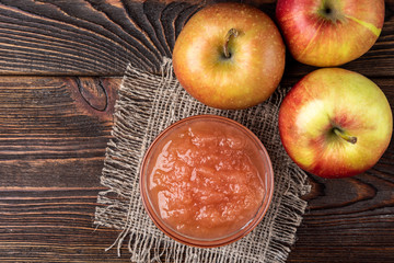 Apple jam on dark wooden background. 