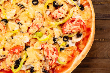 Appetizing pizza on a wooden background
