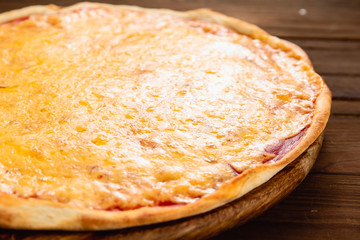 Appetizing pizza on a wooden background