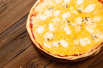 Appetizing pizza on a wooden background