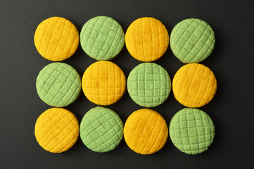 Colorful macaroons on black background