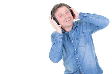 caucasian man on white wall listening to music with headphones and dancing