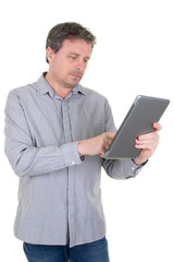 Trendy 40 year old man working looking with tablet on white background