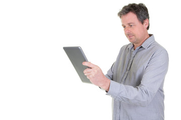 Smiling man playing on digital tablet on white background