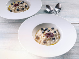Oatmeal with butter and berries. Delicious and healthy breakfast concept