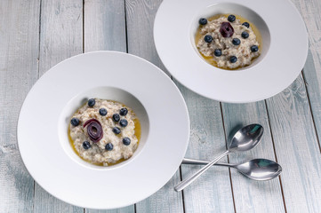 Oatmeal with butter and berries. Delicious and healthy breakfast concept