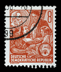 Stamp issued in Germany - Democratic Republic (DDR) shows Learning youth, Karl Marx picture in the background, Five-year Plan serie, circa 1953.