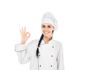 Smiling chef in hat showing okay sign isolated on white