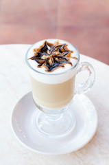 Transparent glass with latte or cappuccino.