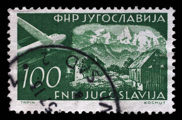 Stamp issued in Yugoslavia shows Gozd-Martuljak, Airplanes and Landscapes series, circa 1951.