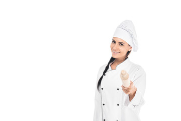 Chef in hat holding rolling pin isolated on white