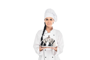 Chef in hat holding tray with cloche isolated on white