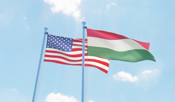 Hungary and USA, two flags waving against blue sky. 3d image