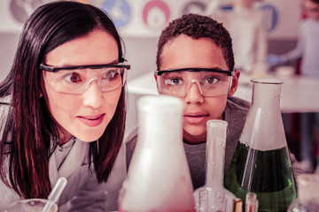 Watchful teacher and her curious ward intently examining reactions