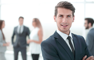 young successful businessman on background of office.