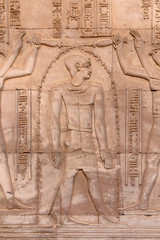 hieroglyphs on a wall at the Temple of Kom Ombo in the Nile river at sunset, Egypt