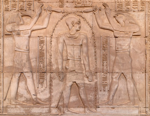 hieroglyphs on a wall at the Temple of Kom Ombo in the Nile river at sunset, Egypt