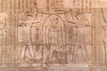 hieroglyphs on a wall at the Temple of Kom Ombo in the Nile river at sunset, Egypt