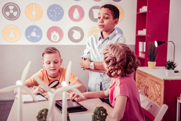 Fototapeta premium Little students sitting in class room and playing